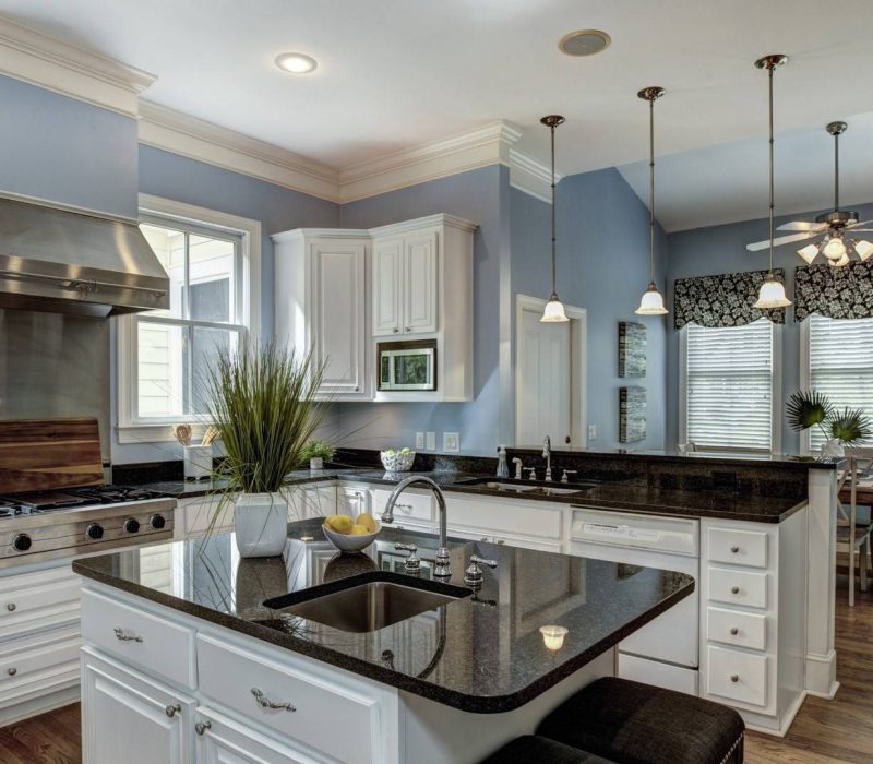 Large American style kitchen and dining room interior with granite countertops